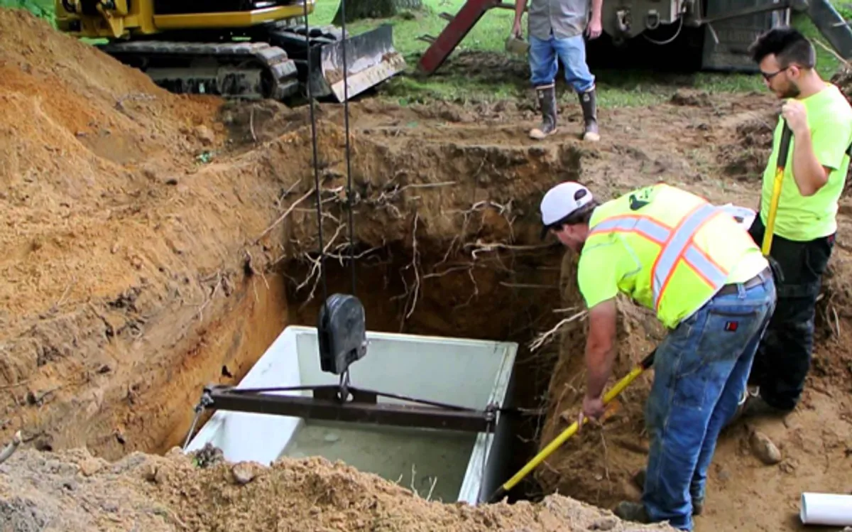 Heavy excavator preparing a residential site for foundation protection and drainage system installation in Memphis, TN