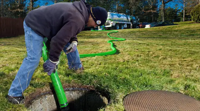 Service technician performing residential septic pumping and drainage maintenance in Memphis, TN